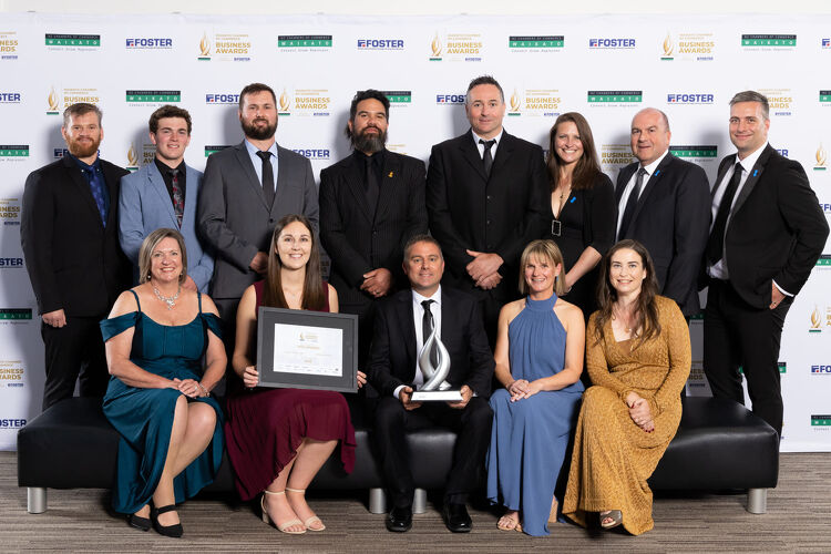 EAS Waikato team celebrating on stage at a business awards ceremony