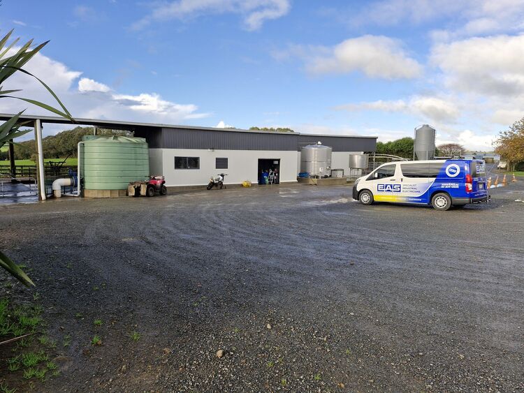 EAS Waikato van parked outside a rural dairy shed with storage tanks
